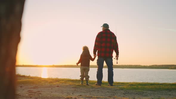 Cute Toddler and His Grandfather are Amazing Beautiful Sunset on River or Lake Old Man and Grandson