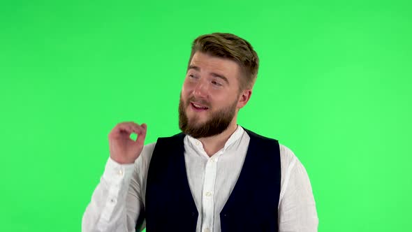 Man Talking and Pointing Side Hand for Something, with Copy Space. Green Screen