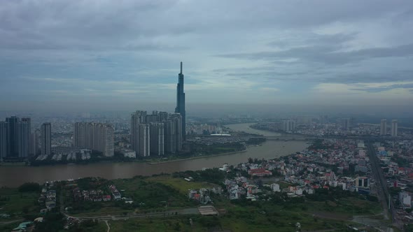 Long Fly in towards river and modern city development with high rise towers in early morning. Part T