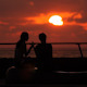 Couple Sitting at the Promenade in the Sunset - VideoHive Item for Sale