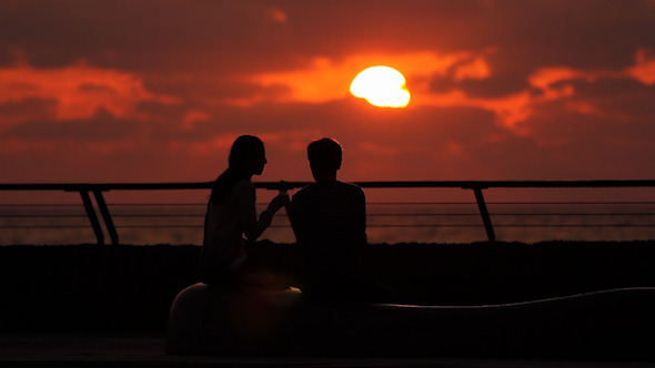 Couple Sitting at the Promenade in the Sunset