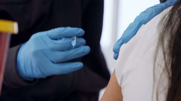 Paramedic giving people the COVID-19 vaccine injection during the vaccination operation