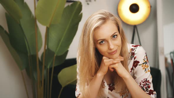 Charming Blonde Young Woman Looking at the Camera and Smiling Living Room Medium Closeup Indoors
