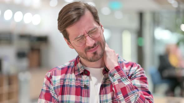 Portrait of Stressed Male Designer Having Neck Pain