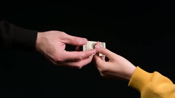 Exchange of a dose of a drug for money on a black background