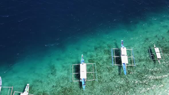 Aerial Fly-Over View of Boats at Entalula Island, Bacuit Bay, El-Nido. Palawan Island, Philippines