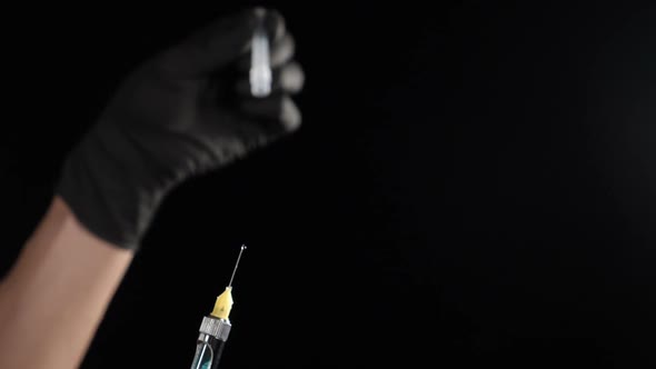 Dental Concept Shot on Black Background. Dentist Holding Syringe with Anesthetic. Medicine, Doctor