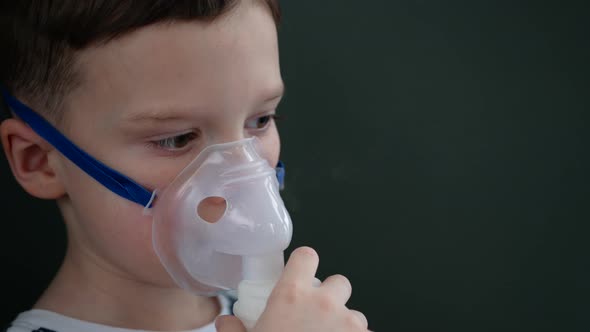 Child inhale using a nebulizer. Little boy in a nebulizer mask