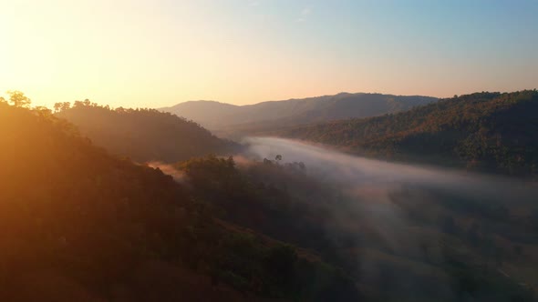 4K Flying through the clouds above mountain tops