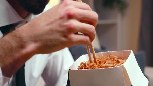 Close Up of Tired Entrepreneur Eating Noodles