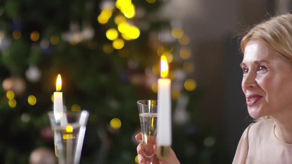 Happy Caucasian Lady Enjoying Champagne with Husband at New Year’s Eve Dinner