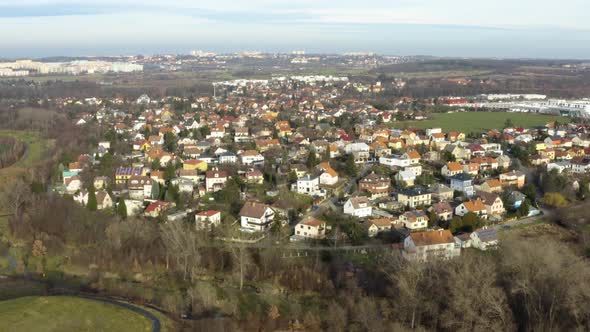 Aerial Shot of Part of the City with Houses and Surrounding Nature During Winter on Sunny Day