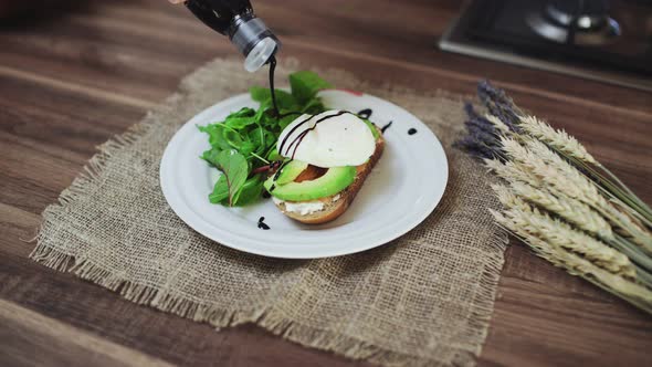 Bruschetta with Salmon, Avocado, Cottage Cheese and Poached Egg on the Table