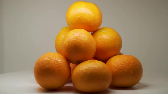 Beautiful Piles Of Juicy Orange Fruits Rotating and Spinning With White Background - Close Up Shot