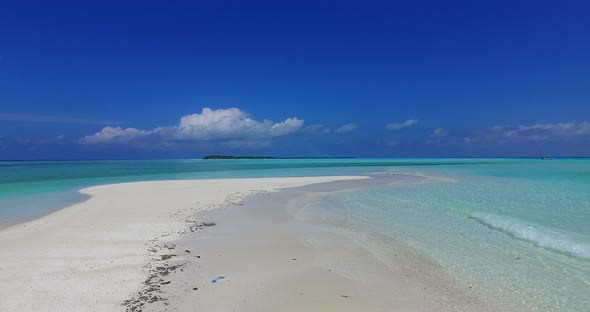 Daytime fly over abstract shot of a summer white paradise sand beach and blue ocean background in vi