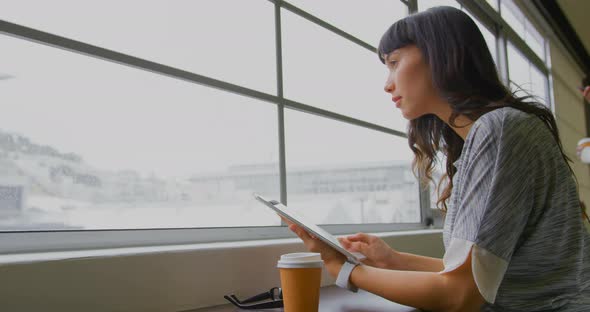 Businesswoman using digital tablet near window in a modern office 4k