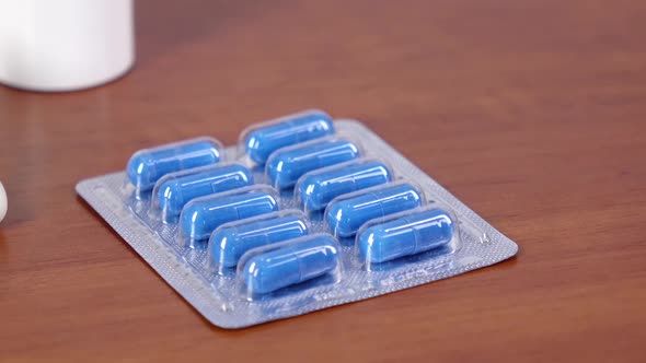 Doctor Takes Blue and Green Medical Pills