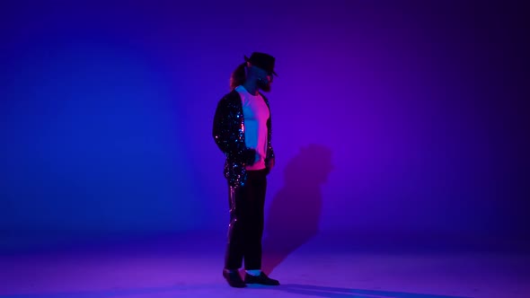 Young Stylish Teenager Is Showing Dance Moves. Isolated Over Blue Background.