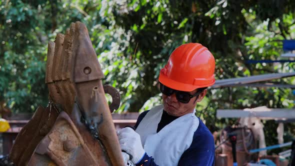 Professional men wearing goggles and construction gloves work in home workshop.