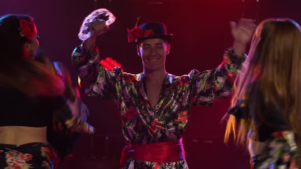 Three Adorable Woman and One Man are Dancing in Gypsy Costumes