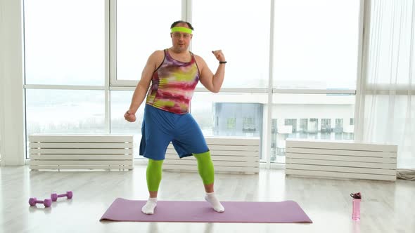 Expressive Overweight Man in 90s Style Clothes Dancing in White Studio