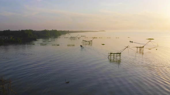 Local fishing trap net in canel, lake or river at sunset. Nature landscape fisheries and fishing