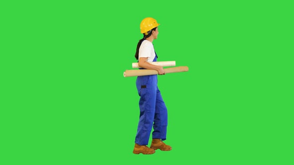 Woman Holding Wallpaper Rolls Walking on a Green Screen Chroma Key