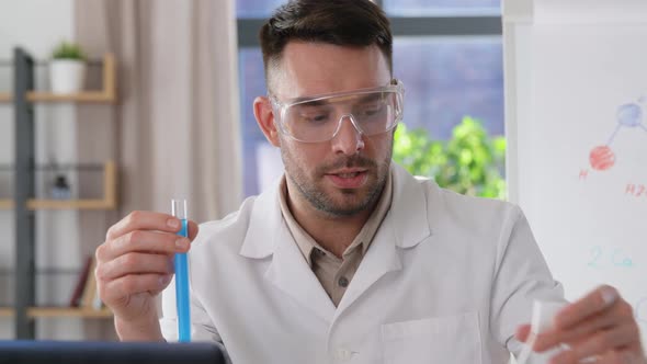 Chemistry Teacher with Laptop Having Online Class