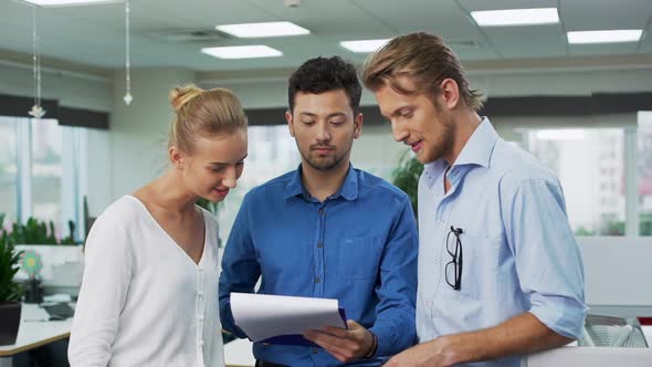 Young Confident Succesful Colleagues Discussing Projects at Office Finding Agreement Shaking Hands