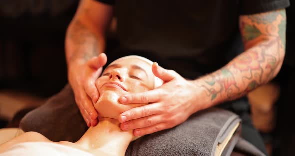 Woman Receiving Facial Relaxing Lymph Drainage Massage