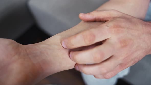 Man Scratching Itchy Reddened Hand