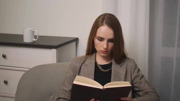 Young Woman Reading Book in Cozy Living Room Learning Studying Education Read Books Stay Home