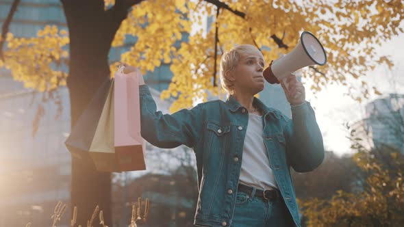 Early Christmas Shopping. November Discounts. Blonde Girl with Shopping Bags Announcing Sales Season