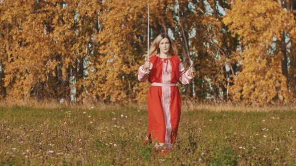 Medieval Concept - Woman in Red National Long Dress Rotating Two Swords Up and Down