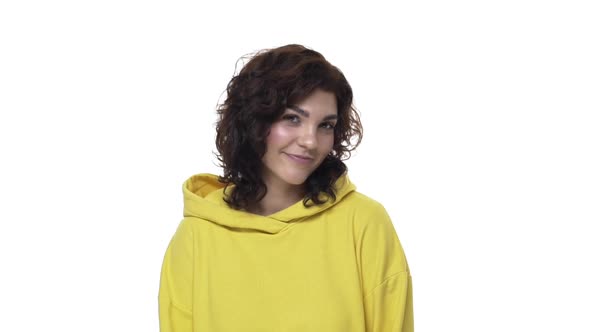 Coquettish and Flirty Curly Girl in Hoodie Glancing Camera Smiling Silly and Feminine Gaze From Down
