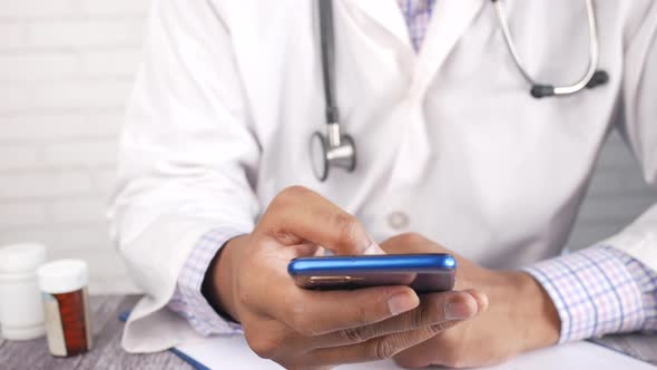 Doctor in White Coat Using a Smartphone