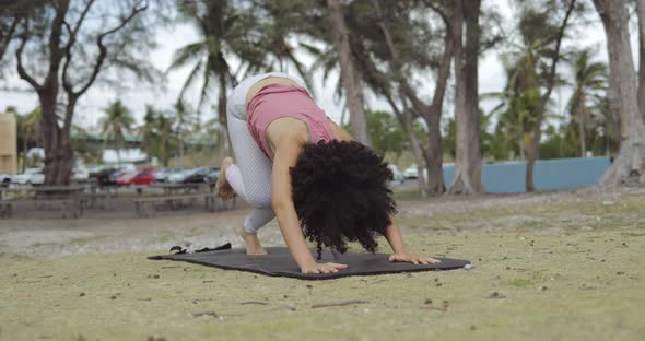 Concentrated Young Girl Stretching Body on Lawn