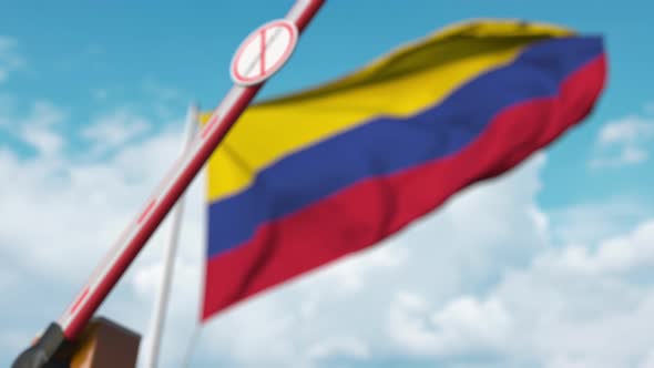 Closed Gate with STOP CORONAVIRUS Sign on Colombian Flag Background