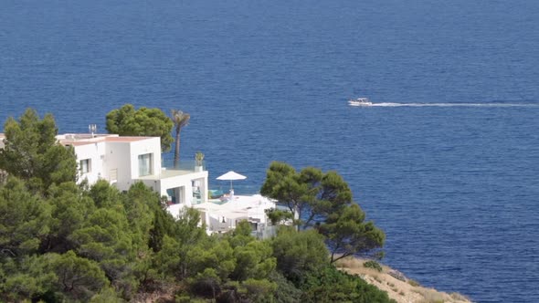 Villa with distant boat passing by