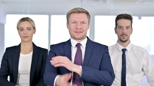 Portrait of Cheerful Professional Team Standing with Arms Crossed