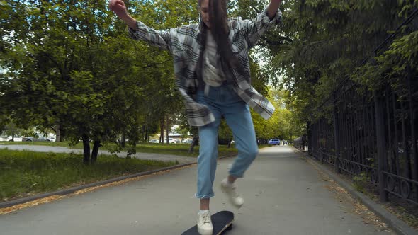 Teenage girl skateboarding in park