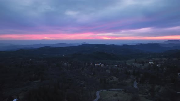 Hyper Lapse Drone Aerial View of Cinematic Pink Sunset Under Scenic Blue Clouds