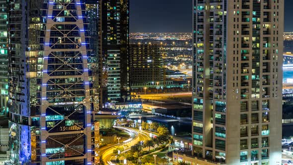 Buildings of Jumeirah Lakes Towers with Traffic on the Road Night Timelapse