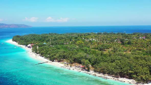 Aerial view scenery of tranquil coastline beach trip by aqua blue lagoon with white sand background 