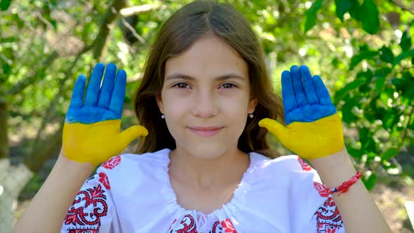 The Ukrainian Flag is Drawn on the Child Hands