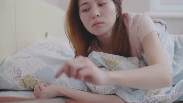 Attractive Asian Woman Waking up in Early Morning