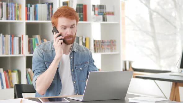 Casual Redhead Man Talking on Phone, Negotiating Contract