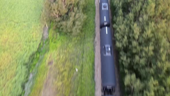 Revealing 4k aerial footage of a long freight train in Alberta's countryside during sunset. Colourfu