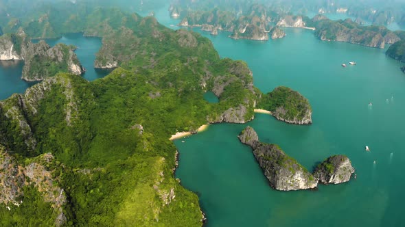 Aerial: flying over Ha Long Bay rock pinnacles, famous tourism destination in Vietnam