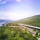 beautiful expressway in a green forest with a dam on the side of the road between mountains. - VideoHive Item for Sale